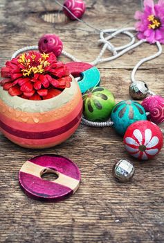 accessories of beads and threads for needlework on wooden plank
