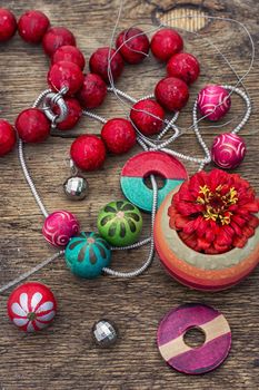 accessories of beads and threads for needlework on wooden plank