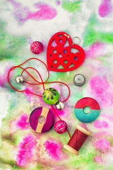 Set beads,threads and fittings on  painted background.