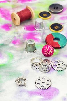 Set beads,threads and fittings on  painted background.