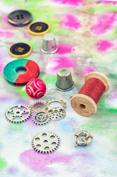 Set beads,threads and fittings on  painted background.