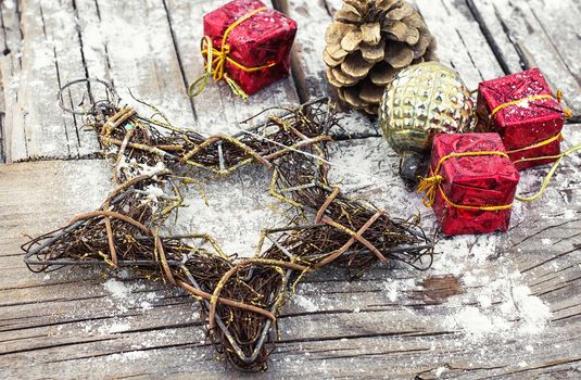 Decorative Christmas star from a wire and decoration on wooden background