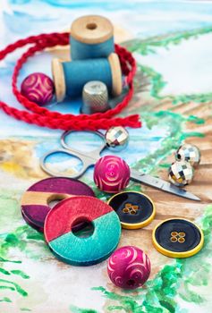 accessories of beads and threads for needlework on wooden plank