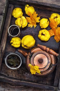 Copper kettle brewing and quinces in an old stylish derevna box
