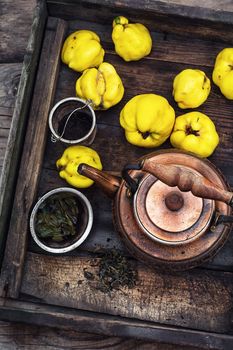 Copper kettle brewing and quinces in an old stylish derevna box