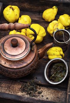Copper kettle brewing and quinces in an old stylish derevna box