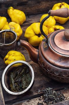 Copper kettle brewing and quinces in an old stylish derevna box