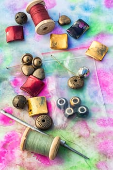 Beads and tools for needlework on bright background
