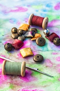 Beads and tools for needlework on bright background
