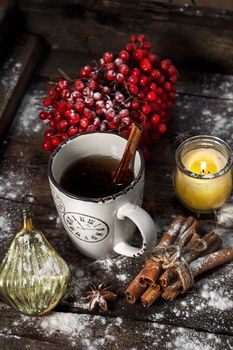 Still life with viburnum tea and and Christmas decorations in retro style.