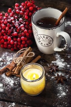 Still life with viburnum tea and and Christmas decorations in retro style.