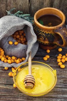 Clay mug with medicinal decoction of sea buckthorn and honey