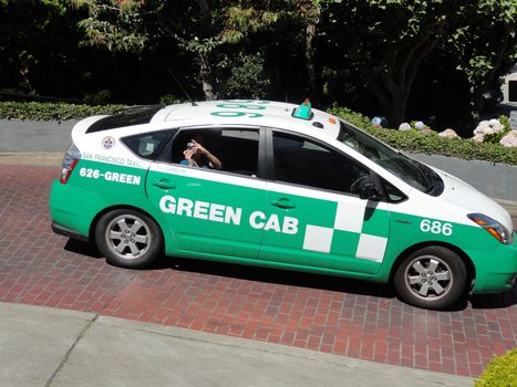 San Francisco, USA - July 22 2010: Toyota Prius Hybrid Taxi on the famous Lombard Street. Green Cab (SF Green Cab) is an Ecological Taxi company located in San Francisco, California