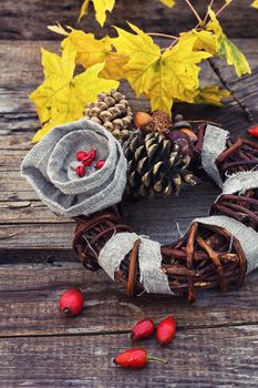 their woven vine wreath decorated with pine cones and autumn acorns