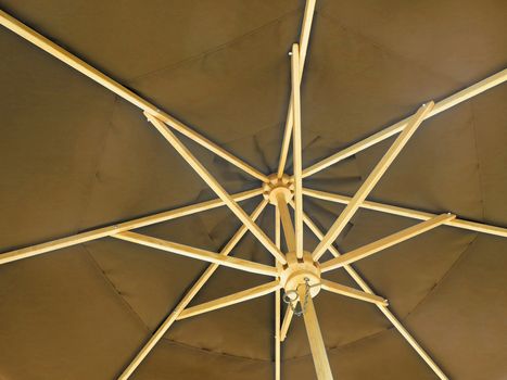 The inside of an open brown umbrella
