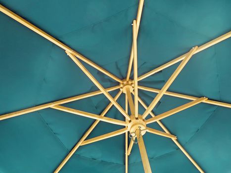 The inside of an open blue umbrella