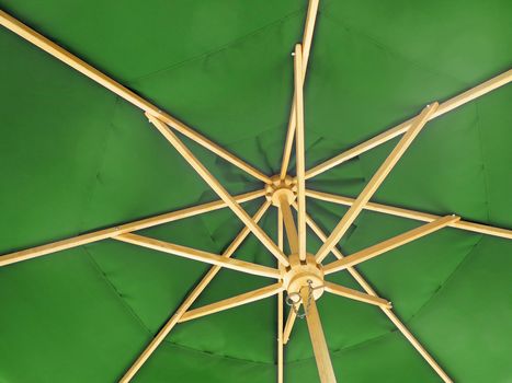 The inside of an open green umbrella