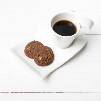 coffee cup with cookie on white wood background