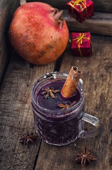 glass of hot wine with aromatic spices in  stylish wooden box