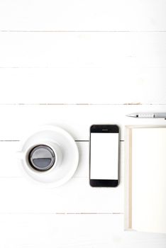 coffee cup with phone and notebook on white wood table