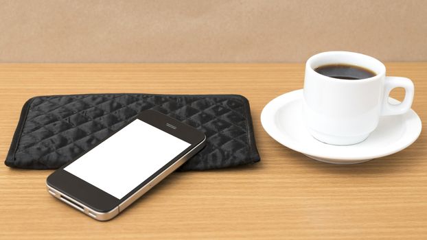 coffee cup and phone and wallet on wood table