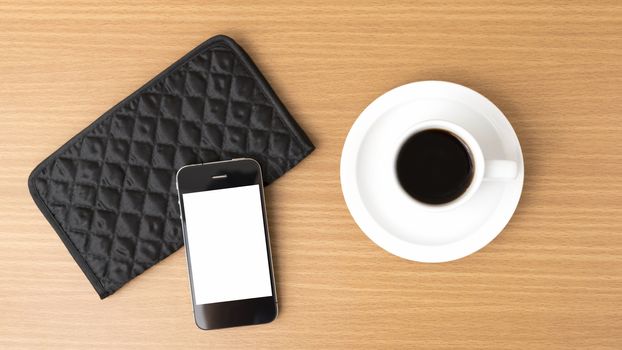 coffee cup and phone and wallet on wood table