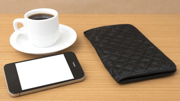 coffee cup and phone and wallet on wood table