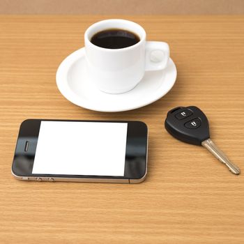 coffee cup and phone and car key on wood background