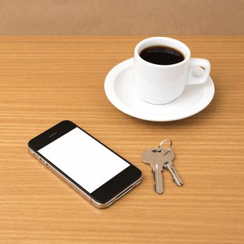 coffee cup and phone and key on wood background