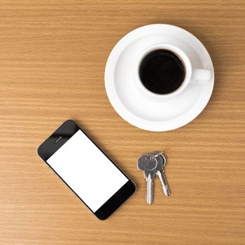 coffee cup and phone and key on wood background
