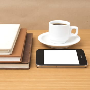 coffee cup and phone and stack of book on wood background