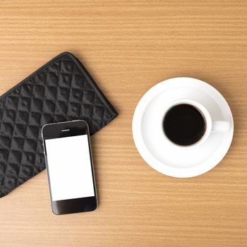 coffee cup and phone and wallet on wood table