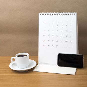 coffee cup and phone and calendar on wood background
