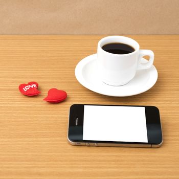 coffee cup and phone and heart on wood background