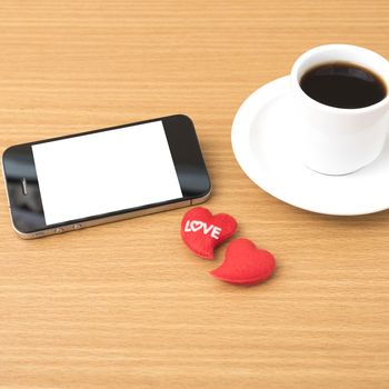 coffee cup and phone and heart on wood background