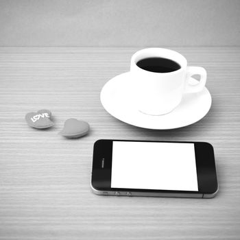 coffee cup and phone and heart on wood background black and white color