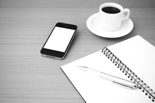 coffee cup and phone and notepad on wood background  black and white color