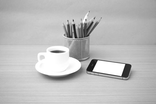 coffee cup and phone with color pencil on wood background black and white color