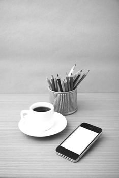 coffee cup and phone with color pencil on wood background black and white color