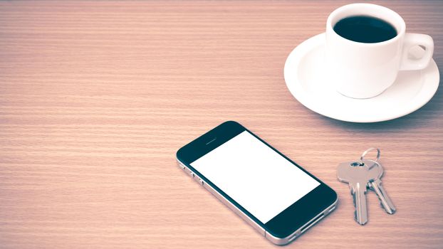 coffee cup and phone and key on wood background vintage style