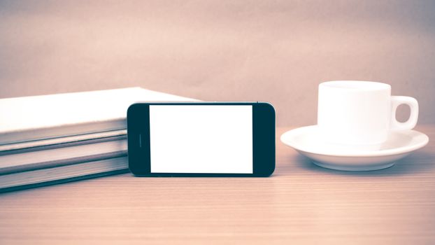 coffee cup and phone and stack of book on wood background vintage style