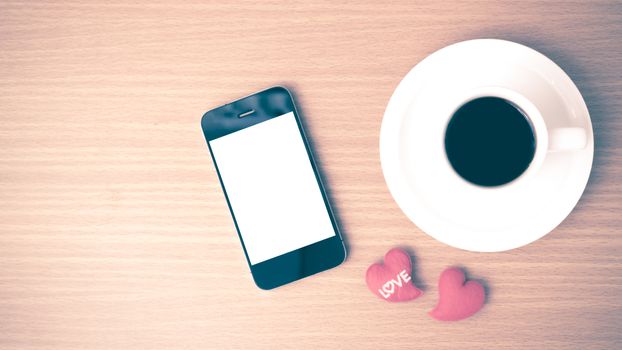 coffee cup and phone and heart on wood background vintage style
