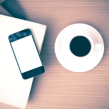 coffee cup and phone and stack of book on wood background vintage style
