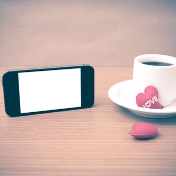 coffee cup and phone and heart on wood background vintage style