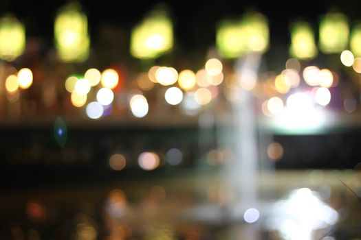Blurred background bokeh night with a fountain.