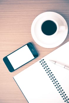 coffee cup and phone and notepad on wood background vintage style