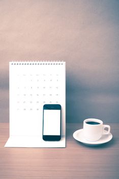 coffee cup and phone and calendar on wood background vintage style