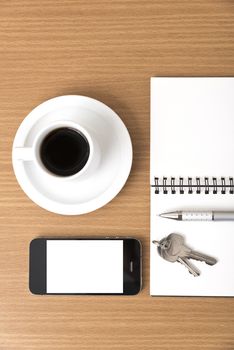 coffee cup with phone car key and notepad on  wood background