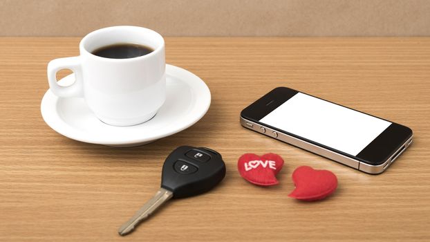 coffee phone car key and heart on wood table background