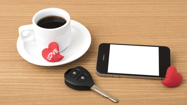 coffee phone car key and heart on wood table background
